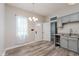 Updated kitchen featuring stainless steel appliances, neutral cabinets and hardware, and wood floors at 3035 N Capitol Ave, Indianapolis, IN 46208