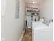 Laundry room with newer washer and dryer and storage shelving, ready for efficient home maintenance at 3035 N Capitol Ave, Indianapolis, IN 46208