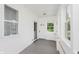 Well-lit porch with many windows, shiplap, and indoor-outdoor carpet at 3035 N Capitol Ave, Indianapolis, IN 46208