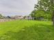 Expansive backyard featuring lush green grass, mature trees, and ample space for recreation at 3223 Keystone Lakes Way, Indianapolis, IN 46237