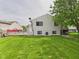 Landscaped backyard with grassy area, patio and privacy fence at 3223 Keystone Lakes Way, Indianapolis, IN 46237