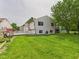 Spacious backyard with lush green grass, wooden deck, and well-maintained lawn, perfect for outdoor activities at 3223 Keystone Lakes Way, Indianapolis, IN 46237