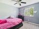 Bedroom with light gray walls, carpeted flooring, bright natural light, and a ceiling fan at 3223 Keystone Lakes Way, Indianapolis, IN 46237