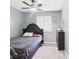 Cozy bedroom with a ceiling fan, neutral walls, and a window providing natural light at 3223 Keystone Lakes Way, Indianapolis, IN 46237