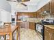 Kitchen with granite countertops, stainless steel appliances, dark wood cabinets, and open view of living room at 3223 Keystone Lakes Way, Indianapolis, IN 46237