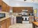 Kitchen with granite countertops, stainless steel appliances, and dark wood cabinets at 3223 Keystone Lakes Way, Indianapolis, IN 46237