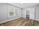 Bedroom features wood-look flooring, neutral walls and trim, window and closet at 3227 Guilford Ave, Indianapolis, IN 46205