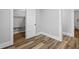 Bedroom shows wood-look flooring, neutral walls and trim, and closet with storage at 3227 Guilford Ave, Indianapolis, IN 46205