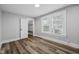 Bedroom features wood-look flooring, neutral walls and trim, a closet and a window at 3227 Guilford Ave, Indianapolis, IN 46205
