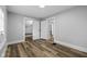 Bedroom shows wood-look flooring, neutral walls and trim, multiple closets and a window unit at 3227 Guilford Ave, Indianapolis, IN 46205