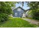 Charming blue two-story house with a well-maintained lawn and a gravel driveway at 3227 Guilford Ave, Indianapolis, IN 46205