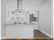 Bright kitchen features white cabinets, stainless steel appliances and a granite countertop island at 3227 Guilford Ave, Indianapolis, IN 46205