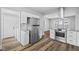 Charming kitchen showcasing new stainless steel appliances, white cabinetry, and wood flooring at 3227 Guilford Ave, Indianapolis, IN 46205