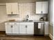Updated kitchen features white cabinets, stainless steel appliances, granite countertops, and a tiled backsplash at 3227 Guilford Ave, Indianapolis, IN 46205