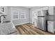 Well-lit kitchen featuring granite countertops, stainless steel appliances, and wood flooring at 3227 Guilford Ave, Indianapolis, IN 46205