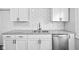 Kitchen features stainless steel dishwasher, granite countertops, and modern backsplash at 3227 Guilford Ave, Indianapolis, IN 46205