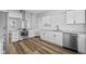 Well-lit kitchen boasts stainless steel appliances, white cabinets, and granite countertops at 3227 Guilford Ave, Indianapolis, IN 46205