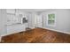 Open-concept living room with hardwood floors and kitchen access at 3227 Guilford Ave, Indianapolis, IN 46205