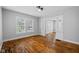 Bright living room featuring hardwood floors, large windows, and fresh paint at 3227 Guilford Ave, Indianapolis, IN 46205