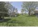 Large backyard features outbuilding and mature trees at 407 N Matthews Rd, Greenwood, IN 46143