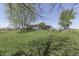 Large lot features manicured lawn, mature shade trees and fenced perimeter at 407 N Matthews Rd, Greenwood, IN 46143