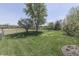Fenced backyard featuring mature trees, fire pit and raised planting beds at 407 N Matthews Rd, Greenwood, IN 46143