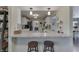 Open kitchen breakfast bar with modern stools and granite countertops, perfect for casual dining at 407 N Matthews Rd, Greenwood, IN 46143