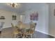 Dining area featuring a round wooden table and hardwood floors, connecting to other living spaces at 407 N Matthews Rd, Greenwood, IN 46143