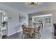 Cozy dining area featuring a hardwood table and chairs, an eye-catching painting, and hardwood floors at 407 N Matthews Rd, Greenwood, IN 46143