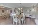 Dining room with an open-concept layout, features hardwood floors, table with chairs, and neutral wall colors at 407 N Matthews Rd, Greenwood, IN 46143