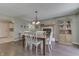 Dining room featuring hardwood floors, a traditional table with chairs, a built-in china cabinet, and fireplace at 407 N Matthews Rd, Greenwood, IN 46143