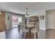 Dining area featuring hardwood floors, a wood table with white chairs, and sliding doors to the outdoor area at 407 N Matthews Rd, Greenwood, IN 46143