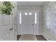 Welcoming foyer with elegant wallpaper and a view of the front door at 407 N Matthews Rd, Greenwood, IN 46143