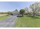 Lovely home with attached two-car garage, shed, pretty landscaping, and a well-kept lawn at 407 N Matthews Rd, Greenwood, IN 46143