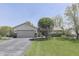 Beautiful ranch home with a two-car garage, well-manicured lawn, and lovely landscaping at 407 N Matthews Rd, Greenwood, IN 46143