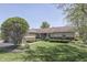 Charming single-story home with a lush green lawn and mature trees at 407 N Matthews Rd, Greenwood, IN 46143