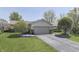 Inviting home with attached two-car garage, pretty landscaping, and a well-kept lawn at 407 N Matthews Rd, Greenwood, IN 46143