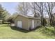 Detached garage with white door and side entry, nestled in a green, landscaped yard at 407 N Matthews Rd, Greenwood, IN 46143