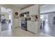 Functional kitchen featuring black appliances and white cabinetry, connected to multiple living areas at 407 N Matthews Rd, Greenwood, IN 46143