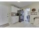 Well-lit kitchen with white cabinetry and black appliances, located near the entrance and other living spaces at 407 N Matthews Rd, Greenwood, IN 46143