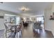 Open-concept living and dining areas with hardwood floors and neutral tones are connected to an eat-in kitchen at 407 N Matthews Rd, Greenwood, IN 46143