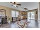 Spacious living room with wood floors, multiple ceiling fans, and access to the outdoor patio at 407 N Matthews Rd, Greenwood, IN 46143