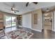 Bright and airy living room featuring wood floors, sliding door to patio, and built-in shelves at 407 N Matthews Rd, Greenwood, IN 46143