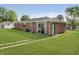 Brick house with a lush green backyard, featuring a sliding glass door and a charming turquoise door at 4126 S Gerrard Dr, Indianapolis, IN 46221