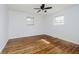 Bright bedroom with hardwood floors, ceiling fan, and natural light from two windows creating a comfortable space at 4126 S Gerrard Dr, Indianapolis, IN 46221