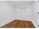 Clean bedroom boasts hardwood floors, a window, and fresh white walls for a minimalist design at 4126 S Gerrard Dr, Indianapolis, IN 46221