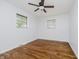 Comfortable bedroom with hardwood floors, a ceiling fan, and two windows providing natural light at 4126 S Gerrard Dr, Indianapolis, IN 46221
