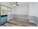 Bright dining area with wood-look floors, wainscoting, and a modern ceiling fan at 4126 S Gerrard Dr, Indianapolis, IN 46221