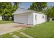 Detached garage with white siding and a turquoise side door, offering both style and functionality at 4126 S Gerrard Dr, Indianapolis, IN 46221