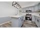 Kitchen features stainless steel appliances, white counters, a kitchen island and gray cabinetry at 4126 S Gerrard Dr, Indianapolis, IN 46221